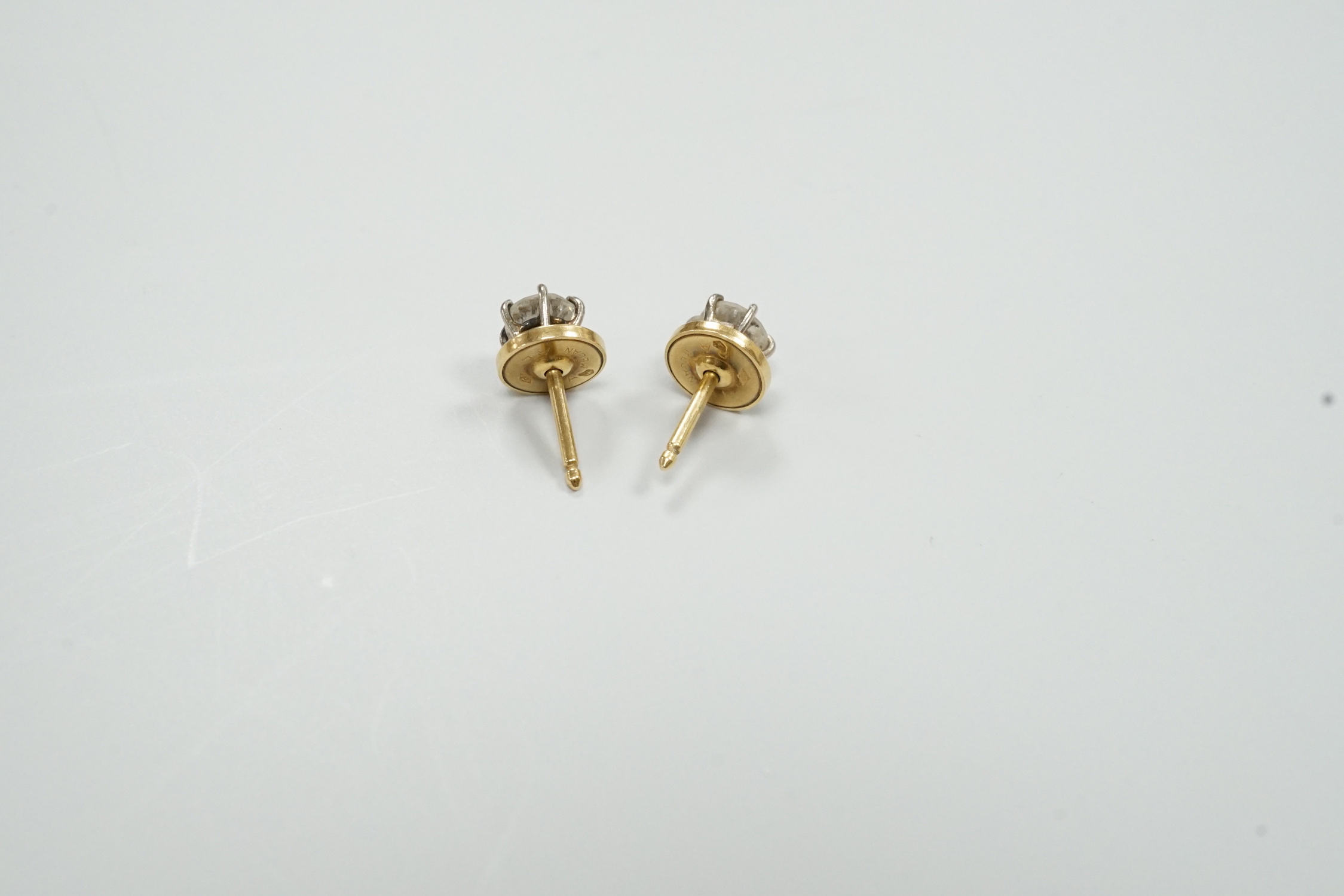 A pair of yellow metal (18ct French poincon mark on discs) and solitaire diamond set ear studs